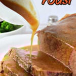Gravy being poured over sliced Beef Bottom Round Roast Slow Cooker style on a white plate with text Slow Cooker Bottom Round Roast.