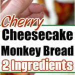 A hand holds a piece of cherry cheesecake cinnamon roll monkey bread with cream on top; text reads 2 Ingredients.