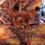 Close-up of tender, saucy flanken-style ribs stacked with text: Fall-Apart ribs in oven (Flanken Short Ribs Recipe).