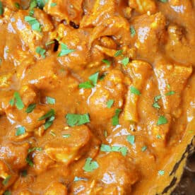 Close-up of creamy Slow Cooker Chicken tikka masala garnished with chopped cilantro.