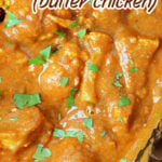 Close-up of Slow Cooker Chicken Makhani in creamy orange sauce, garnished with fresh cilantro.