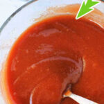 Bowl of rich meatloaf glaze with a spoon, text reads The Best Meatloaf Glaze above the bowl.