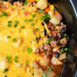 Enjoy this hearty Cowboy Casserole Crockpot dish—cheesy ground beef, potatoes, black beans, corn, and green onions all slow-cooked to perfection.
