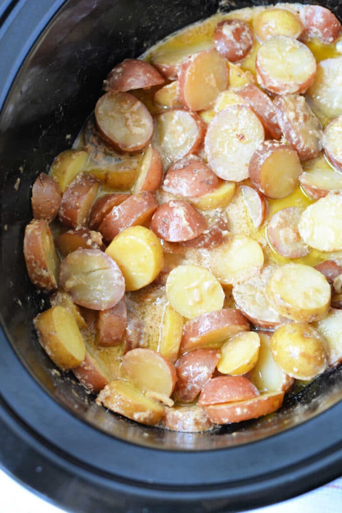 Sliced red potatoes cooked in a creamy sauce inside a slow cooker, this dish is one of the best easy potato recipes and perfect for anyone who loves crockpot potatoes.