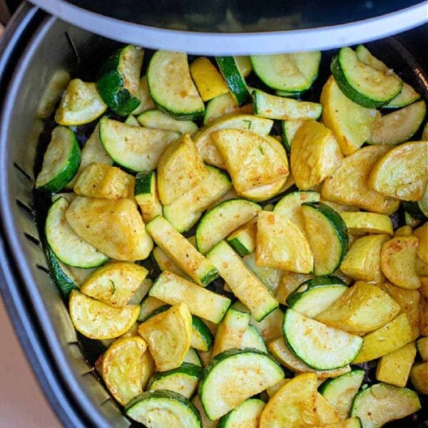 Air Fryer Squash and Zucchini features sliced zucchini and yellow squash, perfectly seasoned and cooked in an air fryer basket for a quick, healthy side dish.