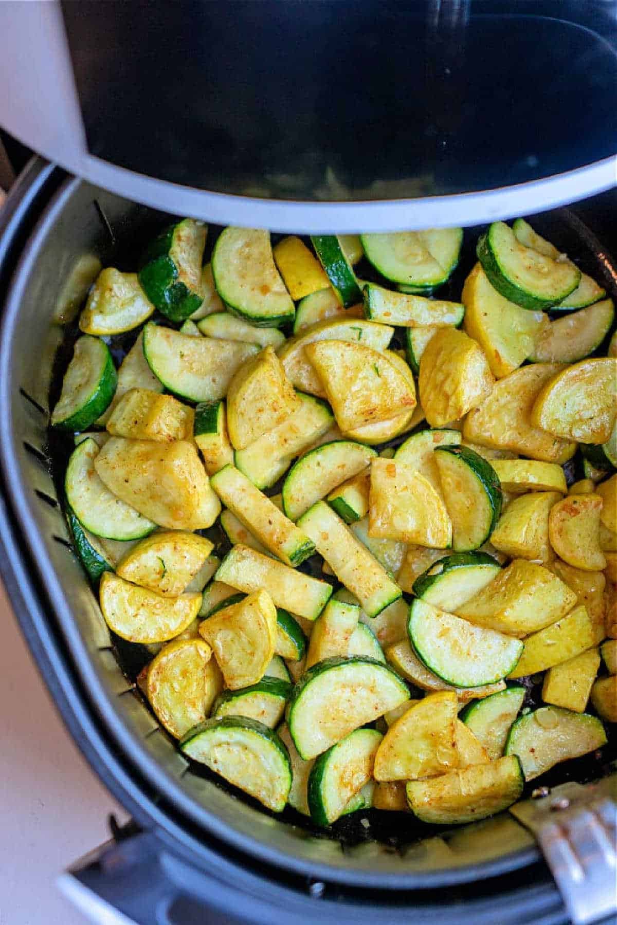 Air Fryer Squash and Zucchini features sliced zucchini and yellow squash, perfectly seasoned and cooked in an air fryer basket for a quick, healthy side dish.